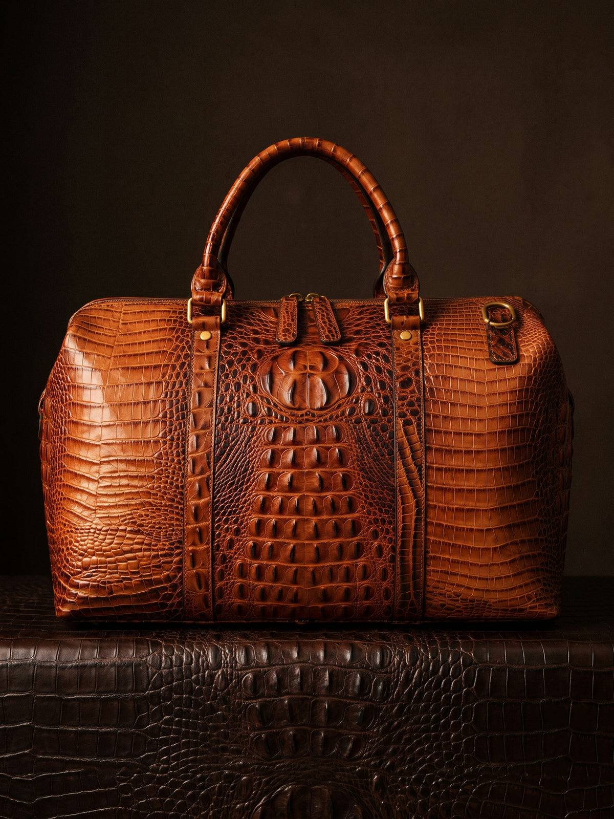 The Deauville Travel Bag — Cognac, still life on crocodile leather