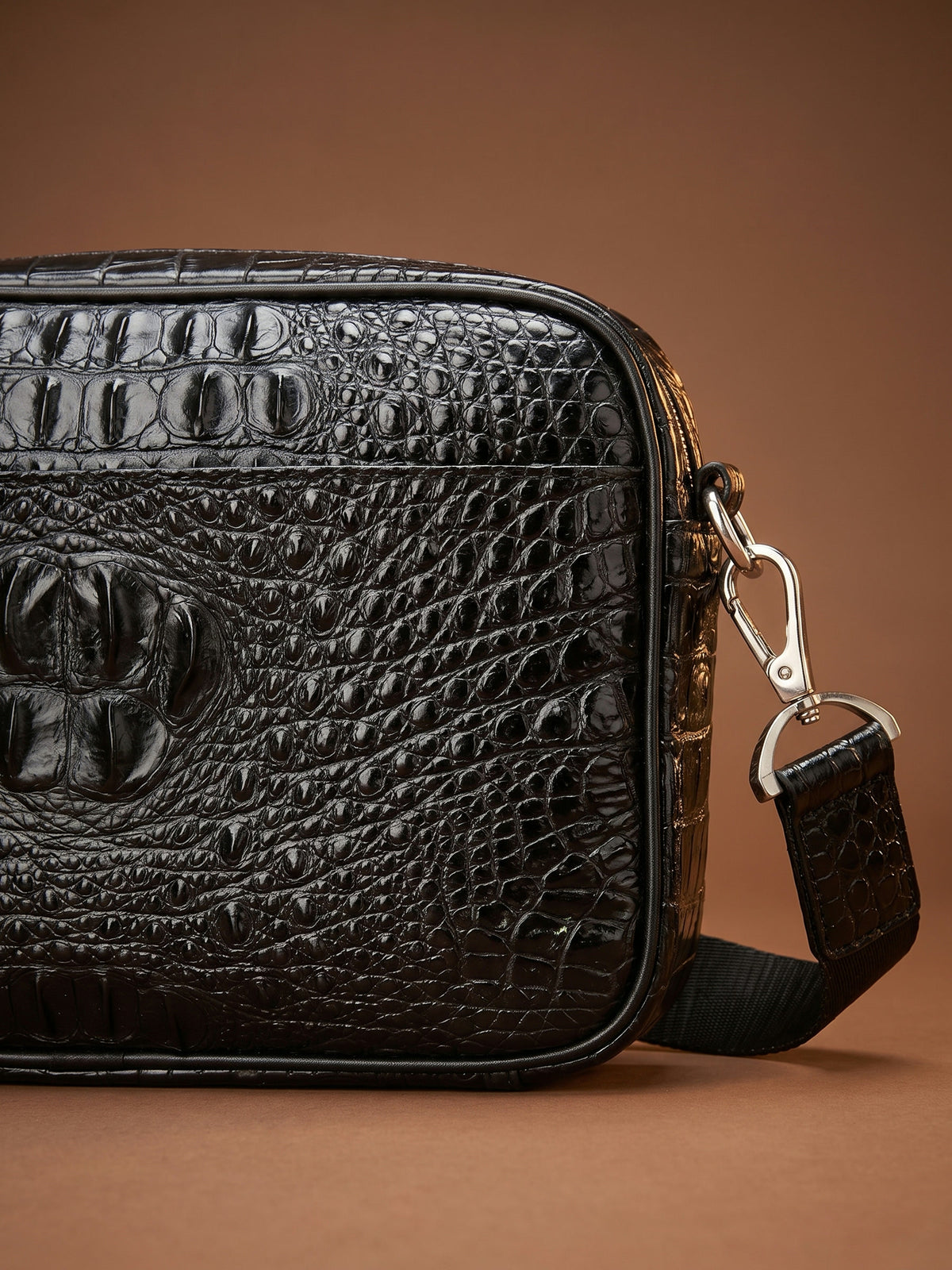 The Cassis Belt Bag — Black, detail of the hornback crocodile embossing