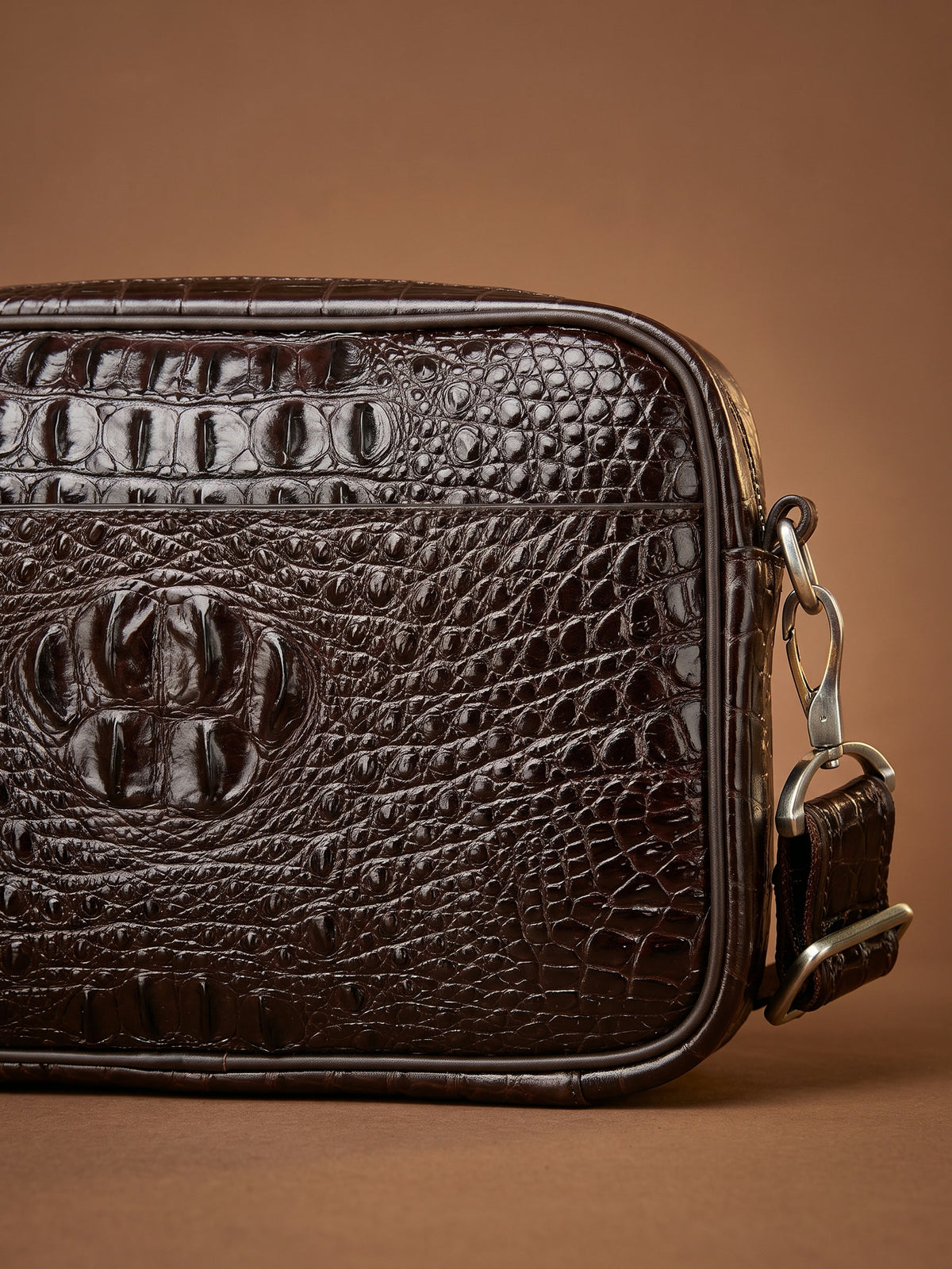 The Cassis Camera Bag — Brown, detail of the hornback crocodile embossing