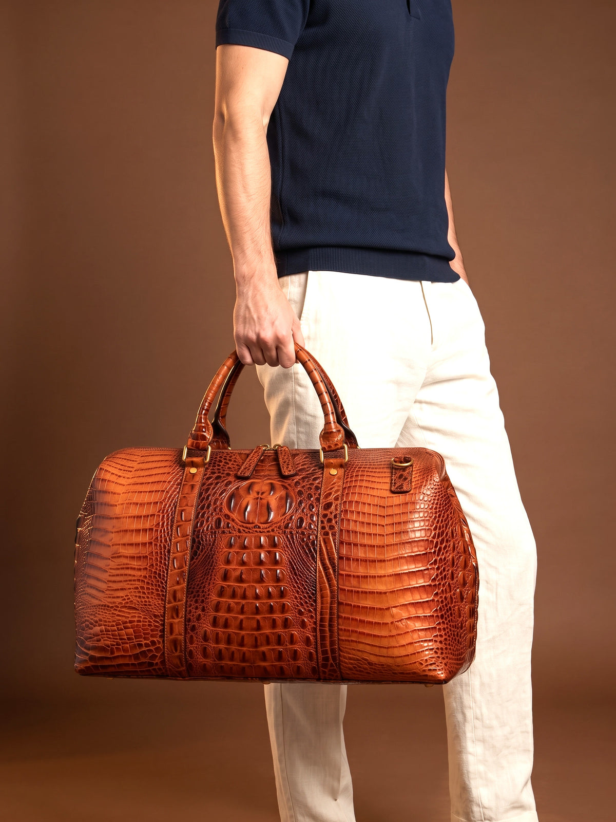 The Deauville Travel Bag — Cognac, carried