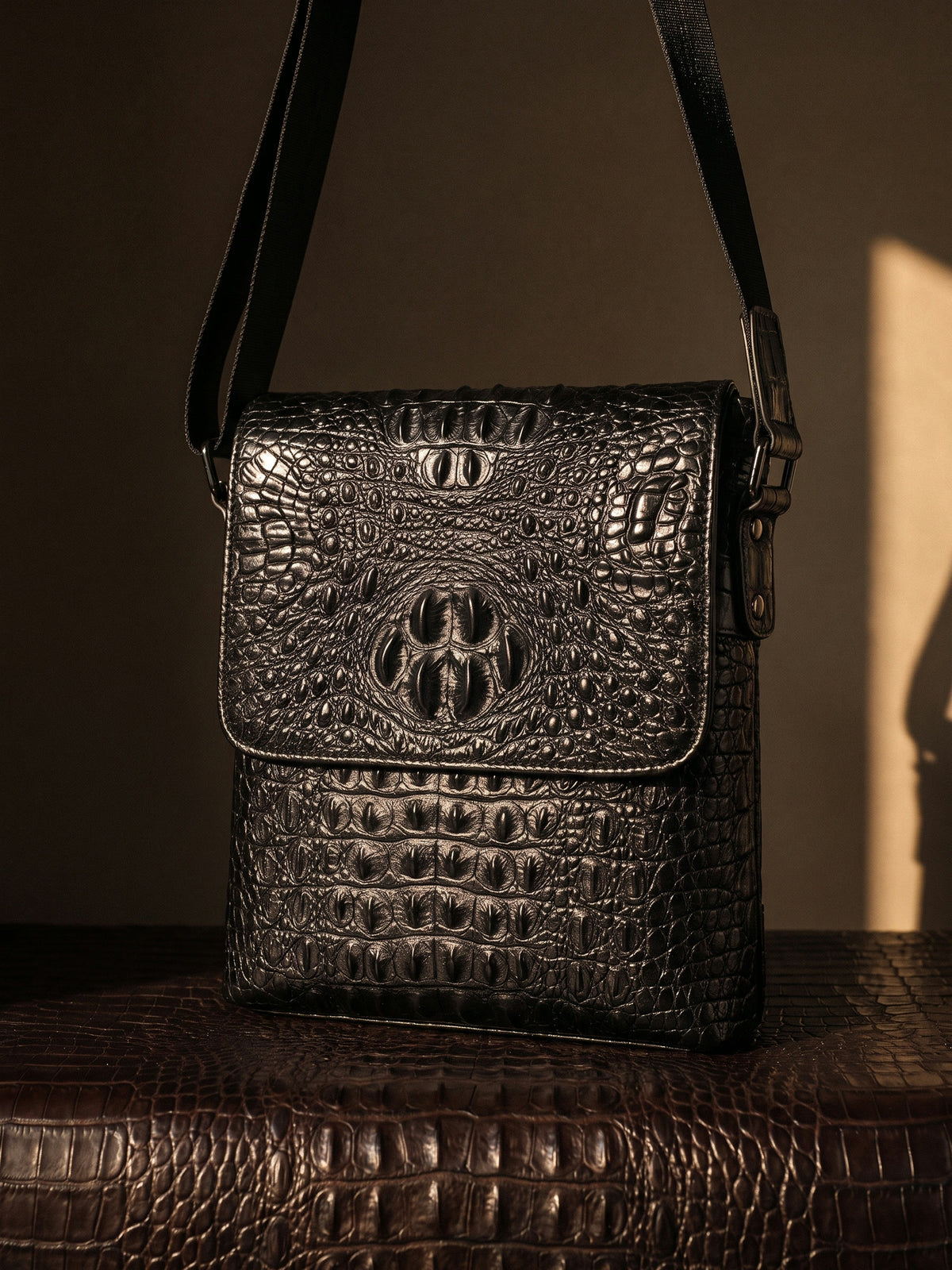 The Biarritz Crossbody — Black, still life on crocodile leather